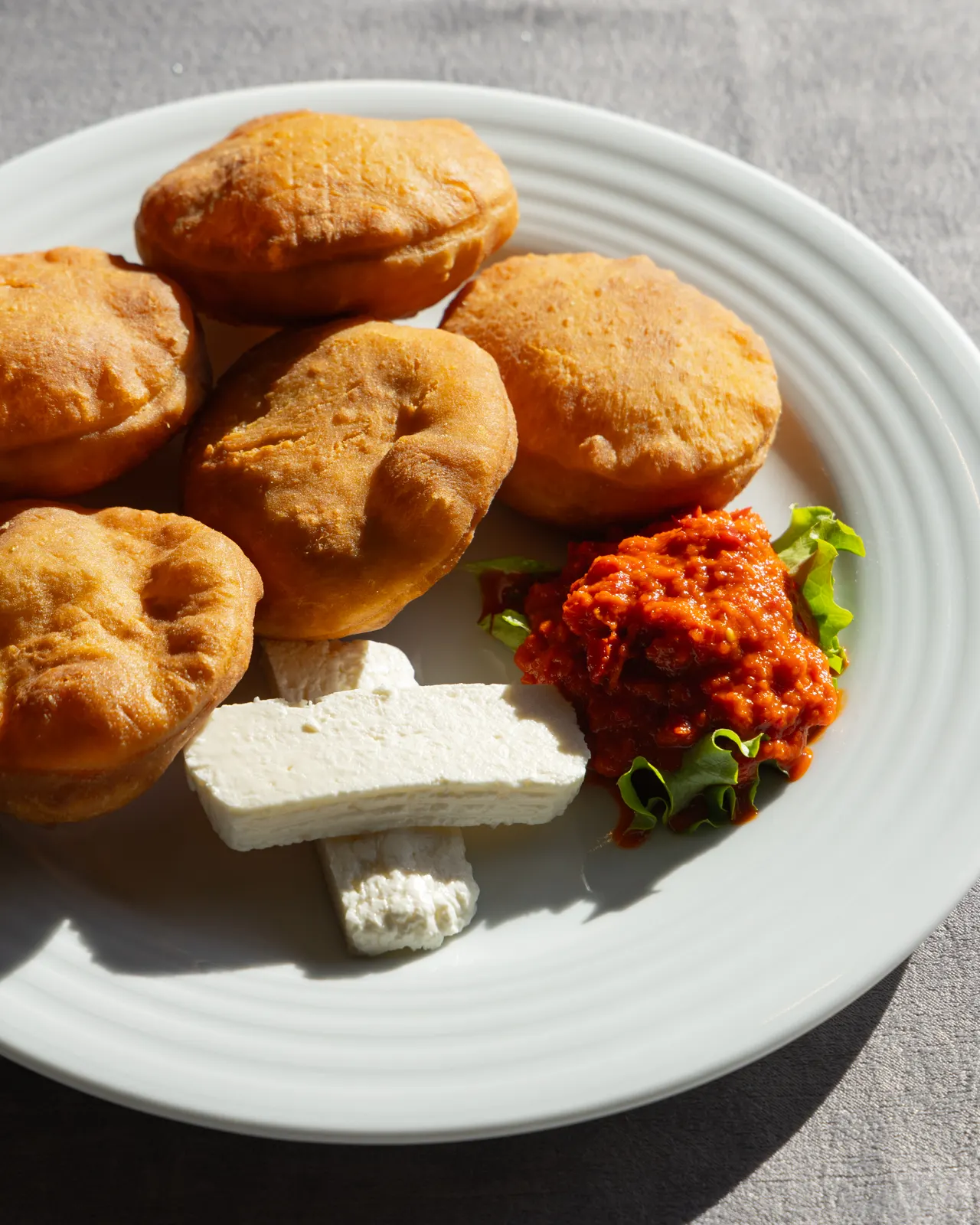 Petulla, white cheese and ajvar on a plate